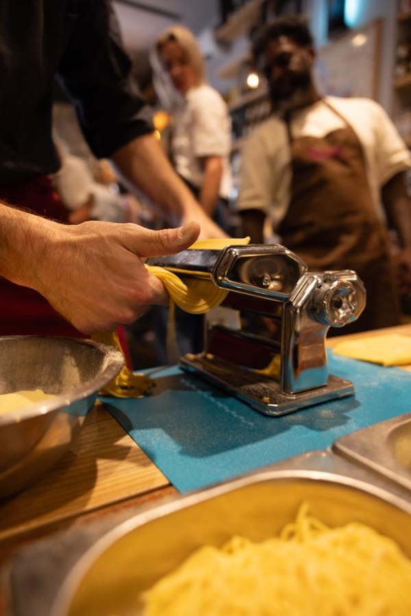 Guests making pasta together during the class