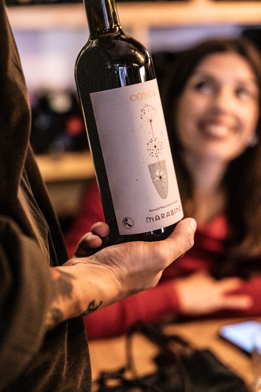 A guest and a bottle of Italian wine at Rimessa Roscioli